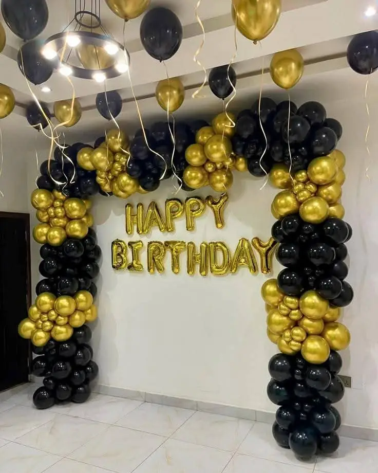 Black and gold birthday balloon arch decoration by New Patna Decorators